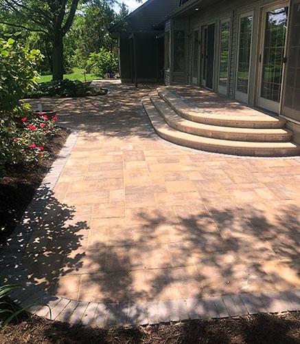 Large outdoor patio area along glass doors to house