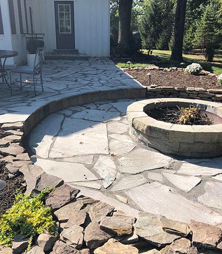 Natural stone patio and fire pit installation