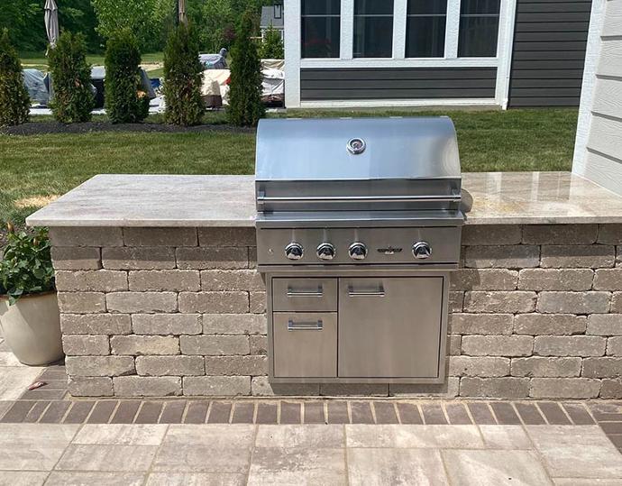 Outdoor kitchen with grill and granite countertop