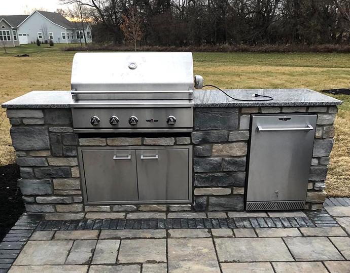 Grill with outdoor kitchen cabinets