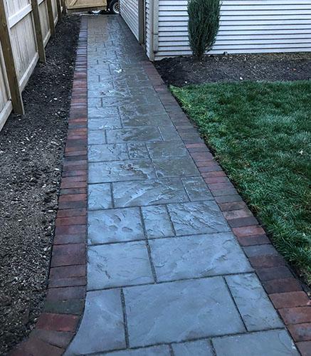 Walkway leading to patio with patio pavers