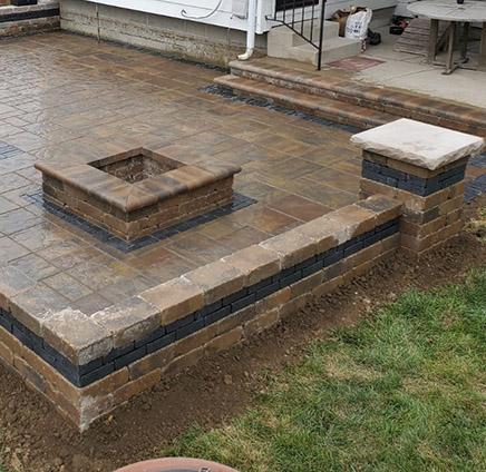 Paver patio with fire pit, seat walls, pillars and outdoor lighting