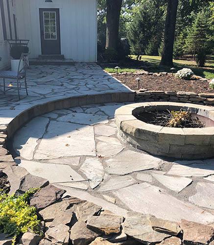 Natural stone fire pit area installation 