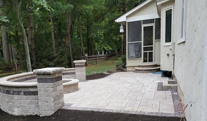 Installed patio and fire pit area with seat walls